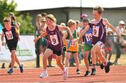 13 August 2022; Paddy Felle, hands the baton to twin sister Sadie, from Woodford-Tynagh, Galway, on their way to winning the u10 4x100m Mixed Relay heat during the Aldi Community Games National Track and Field Finals that attract over 2,000 children to SETU Carlow Sports Campus in Carlow.     Photo by Ramsey Cardy/Sportsfile