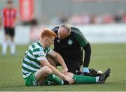 12 August 2022; Rory Gaffney of Shamrock Rovers receives medical attention from physiotherapist Tony McCarthy during the SSE Airtricity League Premier Division match between Derry City and Shamrock Rovers at The Ryan McBride Brandywell Stadium in Derry. Photo by Stephen McCarthy/Sportsfile