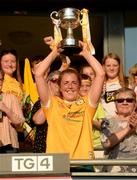 13 August 2022; Antrim captain Cathy Carey lifts the West County Hotel Cup following the TG4 All-Ireland Ladies Junior Football Championship Final Replay between Antrim and Fermanagh at the Athletic Grounds, Armagh. Photo by Oiver McVeigh/Sportsfile