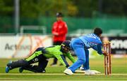 15 August 2022; Simi Singh of Ireland is run out by Azmatullah Omarzai of Afghanistan during the Men's T20 International match between Ireland and Afghanistan at Stormont in Belfast. Photo by Ramsey Cardy/Sportsfile