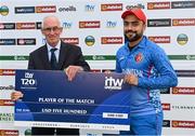 15 August 2022; Rashid Khan of Afghanistan is presented with the player of the match cheque by Cricket Ireland president David Griffin after the Men's T20 International match between Ireland and Afghanistan at Stormont in Belfast. Photo by Ramsey Cardy/Sportsfile