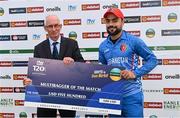 15 August 2022; Rashid Khan of Afghanistan is presented with the multibagger of the match cheque by Cricket Ireland president David Griffin after the Men's T20 International match between Ireland and Afghanistan at Stormont in Belfast. Photo by Ramsey Cardy/Sportsfile
