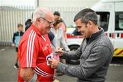 16 August 2022; Former WBA super Bantamweight world champion Bernard Dunne signs a jersey for Mick Lewis, from Cloyne, Cork, before the Hurling for Cancer Research 2022 match at St Conleth's Park in Newbridge, Kildare. Photo by Stephen McCarthy/Sportsfile