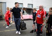 16 August 2022; Paul Murphy of Jim Bolger's Stars chats to Mick Lewis, from Cloyne, Cork, on his arrival for the Hurling for Cancer Research 2022 match at St Conleth's Park in Newbridge, Kildare. Photo by Stephen McCarthy/Sportsfile