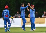 17 August 2022; Mujeeb Zadran of Afghanistan celebrates with teammate Farid Ahmad Malik after bowling out Andrew Balbirnie during the Men's T20 International match between Ireland and Afghanistan at Stormont in Belfast. Photo by Harry Murphy/Sportsfile