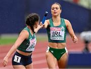 19 August 2022; Sophie Becker of Ireland, right, passes the baton to teammate Phil Healy in the Women's 4x400m Relay heats during day 9 of the European Championships 2022 at the Olympiastadion in Munich, Germany. Photo by Ben McShane/Sportsfile