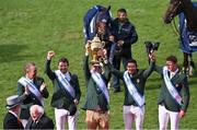 19 August 2022; Ireland Chef d'equipe Michael Blake lifts the Aga Khan trophy alongside riders, from left, Cian O'Connor, Shane Sweetnam, Conor Swail and Max Wachman after their victory in the Longines FEI Jumping Nations Cup™ of Ireland during the Longines FEI Dublin Horse Show at the RDS in Dublin. Photo by Piaras Ó Mídheach/Sportsfile