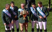 19 August 2022; Ireland Chef d'equipe Michael Blake lifts the Aga Khan trophy alongside riders, from left, Cian O'Connor, Shane Sweetnam, Conor Swail and Max Wachman after their victory in the Longines FEI Jumping Nations Cup™ of Ireland during the Longines FEI Dublin Horse Show at the RDS in Dublin. Photo by Piaras Ó Mídheach/Sportsfile