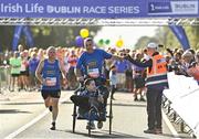 20 August 2022; The Daniel's Voyage team, from left, Shaun Duane, Keith Tighe and Daniel Tighe, high five Jim Aughney at the start of the Irish Life Dublin Race Series Frank Duffy 10 Mile in Phoenix Park in Dublin. Photo by Sam Barnes/Sportsfile