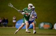 20 August 2022; Jack Doherty of Ireland takes a shot a goal despite the tackle of Robert Ross of Puerto Rico during the 2022 World Lacrosse Men's U21 World Championship 7th place match between Ireland and Puerto Rico at the University of Limerick in Limerick. Photo by Tom Beary/Sportsfile