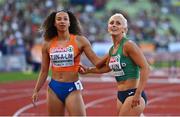 21 August 2022; Sarah Lavin of Ireland, left, and Maayke Tjin A Lim of Netherlands after Heat 2 of the Women's 100m Semi Final during day 11 of the European Championships 2022 at the Olympiastadion in Munich, Germany. Photo by Ben McShane/Sportsfile
