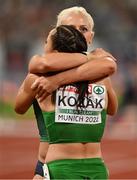 21 August 2022; Sarah Lavin of Ireland congratulates Luca Kozak of Hungary, who won silver, after the Women's 100m Hurdles Final during day 11 of the European Championships 2022 at the Olympiastadion in Munich, Germany. Photo by Ben McShane/Sportsfile