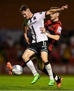 12 August 2022; John Martin of Dundalk is tackled by Rory Feely of Bohemians during the SSE Airtricity League Premier Division match between Bohemians and Dundalk at Dalymount Park in Dublin. Photo by Sam Barnes/Sportsfile