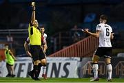 12 August 2022; Referee Adriano Reale shows a yellow card to Sam Bone of Dundalk during the SSE Airtricity League Premier Division match between Bohemians and Dundalk at Dalymount Park in Dublin. Photo by Sam Barnes/Sportsfile