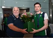 22 August 2022; Mark English of Ireland, right, who won a bronze medal in the men's 800m final, receives flowers from Athletics Ireland President John Cronin at Dublin Airport on the team's return from the European Championships in Munich. Photo by Harry Murphy/Sportsfile