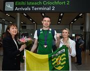 22 August 2022; Mark English of Ireland, who won a bronze medal in the men's 800m final, is greeted by his aunt Bernadette, left, and sister Michelle, right, as he arrives at Dublin Airport on the team's return from the European Championships in Munich. Photo by Harry Murphy/Sportsfile