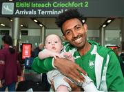 22 August 2022; Efrem Gidey of Ireland with his friends son, 5 month old Kenny O'Neill, at Dublin Airport on the team's return from the European Championships in Munich. Photo by Harry Murphy/Sportsfile
