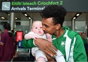 22 August 2022; Efrem Gidey of Ireland with his friends son, 5 month old Kenny O'Neill, at Dublin Airport on the team's return from the European Championships in Munich. Photo by Harry Murphy/Sportsfile
