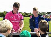 26 August 2022; Joe McCarthy, left, and James Tracy sign autographs at an open training session on day two of the Leinster Rugby 12 Counties Tour at Kilkenny RFC in Kilkenny. Photo by Piaras Ó Mídheach/Sportsfile