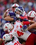 27 August 2022; Northwestern Wildcats running back Evan Hull is tackled by the Nebraska Cornhuskers defence during the Aer Lingus College Football Classic 2022 match between Northwestern Wildcats and Nebraska Cornhuskers at Aviva Stadium in Dublin. Photo by Brendan Moran/Sportsfile