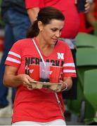 27 August 2022; A Nebraska Cornhuskers supporter carriers beer to her seat during the Aer Lingus College Football Classic 2022 match between Northwestern Wildcats and Nebraska Cornhuskers at Aviva Stadium in Dublin. Photo by Brendan Moran/Sportsfile