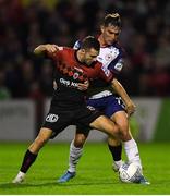29 August 2022; Liam Burt of Bohemians is tackled by Anto Breslin of St Patrick's Athletic during the SSE Airtricity League Premier Division match between Bohemians and St Patrick's Athletic at Dalymount Park in Dublin. Photo by Tyler Miller/Sportsfile