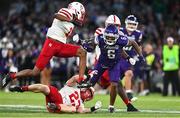 27 August 2022; Northwestern Wildcats wide receiver Malik Washington is tackled by Nebraska Cornhuskers nickel back Isaac Gifford during the Aer Lingus College Football Classic 2022 match between Northwestern Wildcats and Nebraska Cornhuskers at Aviva Stadium in Dublin. Photo by Brendan Moran/Sportsfile