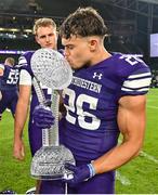 27 August 2022; Northwestern Wildcats running back Evan Hull celebrates with the trophy after the Aer Lingus College Football Classic 2022 match between Northwestern Wildcats and Nebraska Cornhuskers at Aviva Stadium in Dublin. Photo by Brendan Moran/Sportsfile