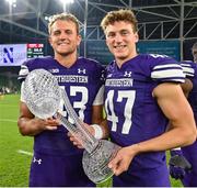 27 August 2022; Northwestern Wildcats long snapper Will Halkyard, left, and punter Luke Akers celebrate with the trophy after the Aer Lingus College Football Classic 2022 match between Northwestern Wildcats and Nebraska Cornhuskers at Aviva Stadium in Dublin. Photo by Brendan Moran/Sportsfile