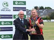 28 August 2022; Cricket Ireland president David Griffin presents Eddie Richardson of North County with the trophy after the Clear Currency National Cup Final match between North County and Terenure at Leinster Cricket Club in Dublin. Photo by Piaras Ó Mídheach/Sportsfile
