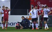 2 September 2022; (EDITORS NOTE; This image contains graphic content) Players of both side's react as Conor Kane of Shelbourne receives medical treatment after picking up a knee injury during the SSE Airtricity League Premier Division match between Dundalk and Shelbourne at Casey's Field in Dundalk, Louth. Photo by Ben McShane/Sportsfile