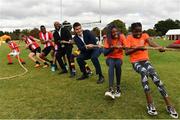 10 September 2022; Minister of State for Sport and the Gaeltacht Jack Chambers, TD, third from right, and Councillor JK Onwumereh, fourth from right, take part in a game of tug of war, alongside Hannele Raji, 13, second from right, her sister Hila Raji, 10, right, both from Drogheda, Louth, and players from Mosney FC in Meath, during the SARI Sportsfest at the Phoenix Park in Dublin, celebrating 25 years of working with sport to promote inclusion, diversity and equality. Photo by Sam Barnes/Sportsfile