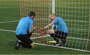 13 September 2022; Referee Rob Harvey, left, and assistant referee Rob Clarke repair the goal nets, resulting in a delayed start to the SSE Airtricity League Premier Division match between Derry City and Sligo Rovers at The Ryan McBride Brandywell Stadium in Derry. Photo by Ramsey Cardy/Sportsfile