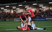 13 September 2022; Shane McEleney of Derry City is helped to his feet by teammates, from left, Patrick McEleney, Mark Connolly and Cameron McJannet during the SSE Airtricity League Premier Division match between Derry City and Sligo Rovers at The Ryan McBride Brandywell Stadium in Derry. Photo by Ramsey Cardy/Sportsfile