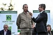 14 September 2022; Team Ireland rider Cian O'Connor, left, is interviewed by MC Brendan McArdle as the The Aga Khan trophy is brought to Tuamgraney, Clare, following Ireland's victory in the Longines FEI Jumping Nations Cup at the Dublin Horse Show. Photo by Sam Barnes/Sportsfile
