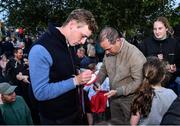 14 September 2022; Team Ireland riders Cian O'Connor, right, and Max Wachman, sign autographs as the The Aga Khan trophy is brought to Tuamgraney, Clare, following Ireland's victory in the Longines FEI Jumping Nations Cup at the Dublin Horse Show. Photo by Sam Barnes/Sportsfile