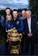14 September 2022; Ireland team manager Michael Blake, right, alongside riders Max Wachman, left, and Cian O'Connor, centre, stand for a photograph with Ray Touhy, and his daughter Ava from Scariff, Clare, as the The Aga Khan trophy is brought to Tuamgraney, Clare, following Ireland's victory in the Longines FEI Jumping Nations Cup at the Dublin Horse Show. Photo by Sam Barnes/Sportsfile