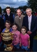 14 September 2022; Ireland team manager Michael Blake, right, alongside riders Max Wachman, left, and Cian O'Connor, centre, stand for a photograph with Lea O'Donovan aged 11, Elaina Quinlan, aged 7, Síofra O'Donovan, aged 8, from Tuamgraney, Clare, as the The Aga Khan trophy is brought to Tuamgraney, Clare, following Ireland's victory in the Longines FEI Jumping Nations Cup at the Dublin Horse Show. Photo by Sam Barnes/Sportsfile