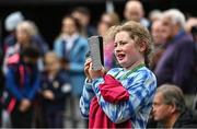14 September 2022; A spectator records a video on her phone as the The Aga Khan trophy is brought to Tuamgraney, Clare, following Ireland's victory in the Longines FEI Jumping Nations Cup at the Dublin Horse Show. Photo by Sam Barnes/Sportsfile