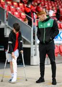 18 September 2022; Derry City supporter Patrick Fox, who recently picked up a knee injury, with Rory Gaffney of Shamrock Rovers before the Extra.ie FAI Cup Quarter-Final match between Derry City and Shamrock Rovers at The Ryan McBride Brandywell Stadium in Derry. Photo by Stephen McCarthy/Sportsfile
