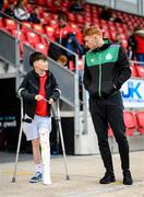 18 September 2022; Derry City supporter Patrick Fox, who recently picked up a knee injury, with Rory Gaffney of Shamrock Rovers before the Extra.ie FAI Cup Quarter-Final match between Derry City and Shamrock Rovers at The Ryan McBride Brandywell Stadium in Derry. Photo by Stephen McCarthy/Sportsfile