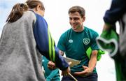 19 September 2022; Jayson Molumby signs autographs for pupils from Latnamard National School, Monaghan, after a Republic of Ireland training session at the FAI National Training Centre in Abbotstown, Dublin. Photo by Stephen McCarthy/Sportsfile