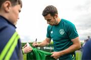 19 September 2022; Seamus Coleman signs autographs for pupils from Latnamard National School, Monaghan, after a Republic of Ireland training session at the FAI National Training Centre in Abbotstown, Dublin. Photo by Stephen McCarthy/Sportsfile