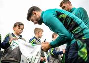 19 September 2022; Robbie Brady signs autographs for pupils from Latnamard National School, Monaghan, after a Republic of Ireland training session at the FAI National Training Centre in Abbotstown, Dublin. Photo by Stephen McCarthy/Sportsfile
