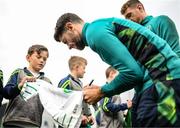 19 September 2022; Robbie Brady signs autographs for pupils from Latnamard National School, Monaghan, after a Republic of Ireland training session at the FAI National Training Centre in Abbotstown, Dublin. Photo by Stephen McCarthy/Sportsfile