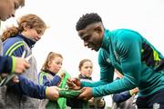 19 September 2022; Chiedozie Ogbene signs autographs for pupils from Latnamard National School, Monaghan, after a Republic of Ireland training session at the FAI National Training Centre in Abbotstown, Dublin. Photo by Stephen McCarthy/Sportsfile