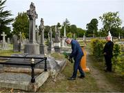 20 September 2022; Uachtarán Chumann Lúthchleas Gael Larry McCarthy, in the company of Monsignor Eoin Thynne, places a wreath on the grave of Michael Cusack at Glasnevin cemetery in Dublin, in a ceremony marking the 175th anniversary of the birth of the Clare school teacher who played a pivotal role in the formation of the GAA in 1884. Photo by Brendan Moran/Sportsfile