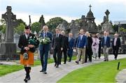 20 September 2022; Led by piper Michael Maher of the Irish United Nations Veterans Pipe Band Association, leads Uachtarán Chumann Lúthchleas Gael Larry McCarthy and members of the GAA on their way to place a wreath on the grave of Michael Cusack at Glasnevin cemetery in Dublin in a ceremony marking the 175th anniversary of the birth of the Clare school teacher who played a pivotal role in the formation of the GAA in 1884. Photo by Brendan Moran/Sportsfile