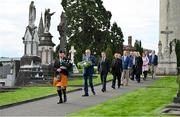 20 September 2022; Led by piper Michael Maher of the Irish United Nations Veterans Pipe Band Association, leads Uachtarán Chumann Lúthchleas Gael Larry McCarthy and members of the GAA on their way to place a wreath on the grave of Michael Cusack at Glasnevin cemetery in Dublin in a ceremony marking the 175th anniversary of the birth of the Clare school teacher who played a pivotal role in the formation of the GAA in 1884. Photo by Brendan Moran/Sportsfile