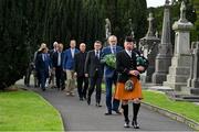 20 September 2022; Led by piper Michael Maher of the Irish United Nations Veterans Pipe Band Association, leads Uachtarán Chumann Lúthchleas Gael Larry McCarthy and members of the GAA on their way to place a wreath on the grave of Michael Cusack at Glasnevin cemetery in Dublin in a ceremony marking the 175th anniversary of the birth of the Clare school teacher who played a pivotal role in the formation of the GAA in 1884. Photo by Brendan Moran/Sportsfile